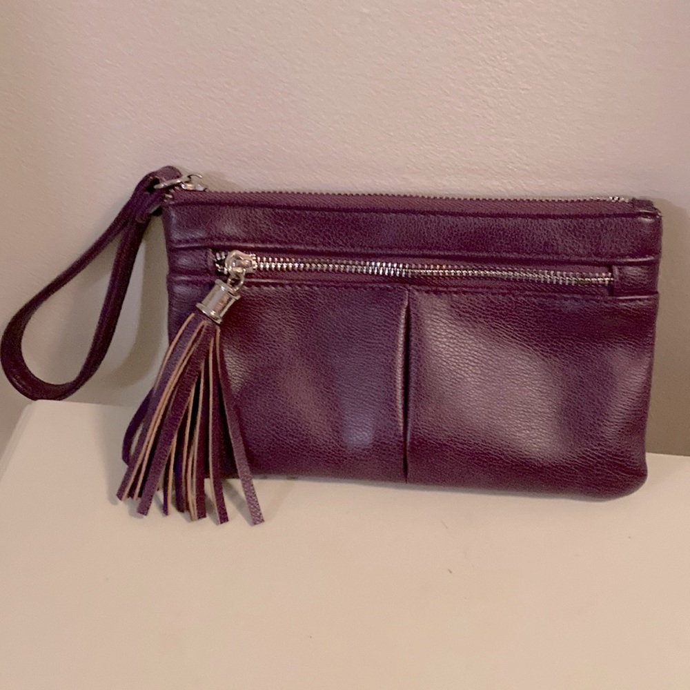 Purple wristlet clutch with two zipper pockets in good condition.